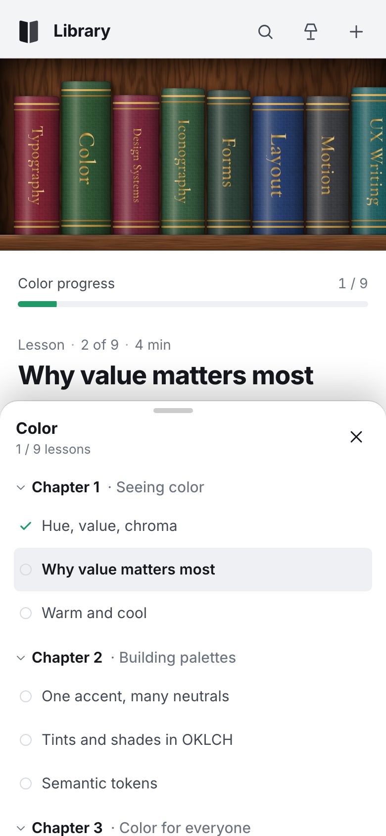The Library on a phone: the header, a strip of cloth spines on one walnut board, the lesson below and the Color course's chapters in a half-open bottom sheet.